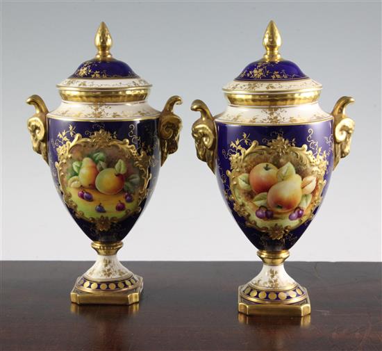 A pair of Coalport fruit painted pedestal vases and covers, post war, 24cm